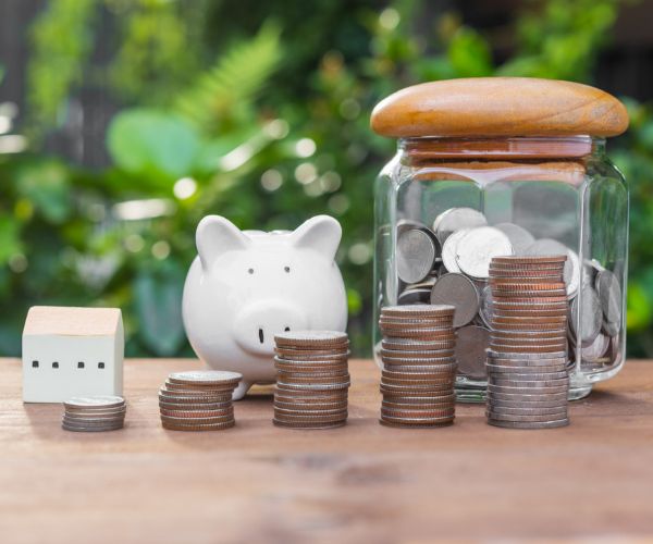 piggy bank on a wooden table with money